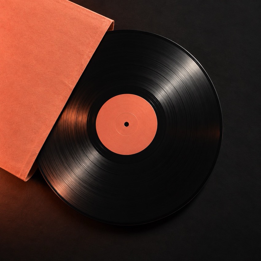 Black vinyl record in a coral sleeve